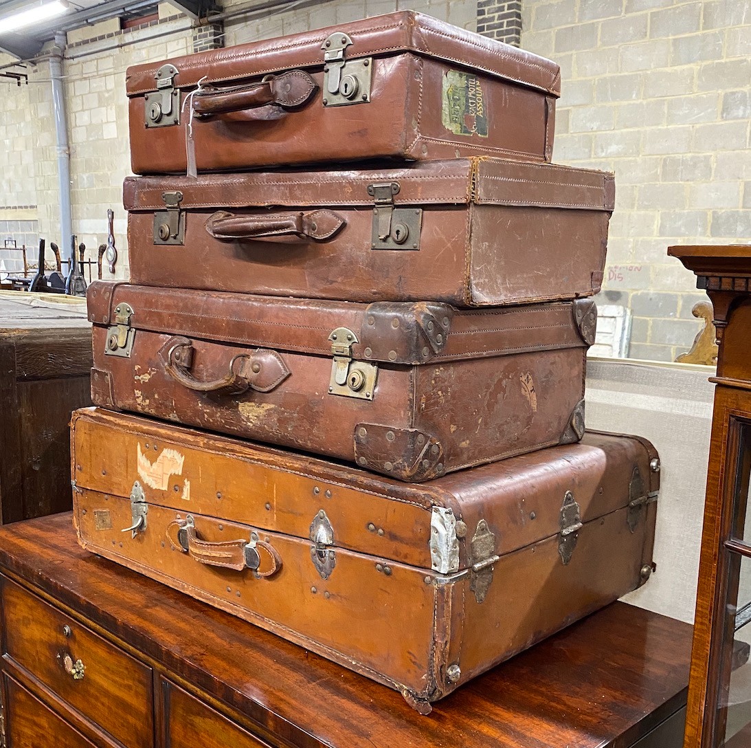 Four vintage suitcases, largest 82 x 53cm